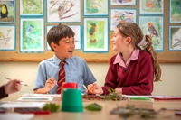 Description: Junior School Boy and Girl in Art Classroom